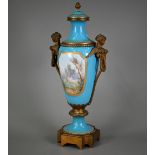 A large 19th century French porcelain vase and cover in the Sevres manner, the reserves painted with