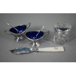 A pair of late Victorian pierced silver open salts with blue glass liners, of oval form with twin