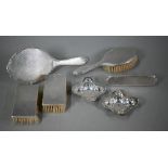 Four engine-turned silver hairbrushes and a hand-mirror, Birmingham 1957, to/w two quatrefoil pin-