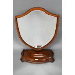 A large Victorian Sheraton Revival mahogany framed adjustable shield shaped toilet mirror, with