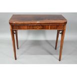 A Victorian figured mahogany inlaid tea table, the fold over top raised on canted square tapering