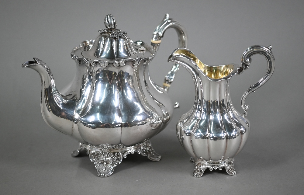 A Victorian silver melon-shaped teapot with cast melon finial and scroll handle with ivory