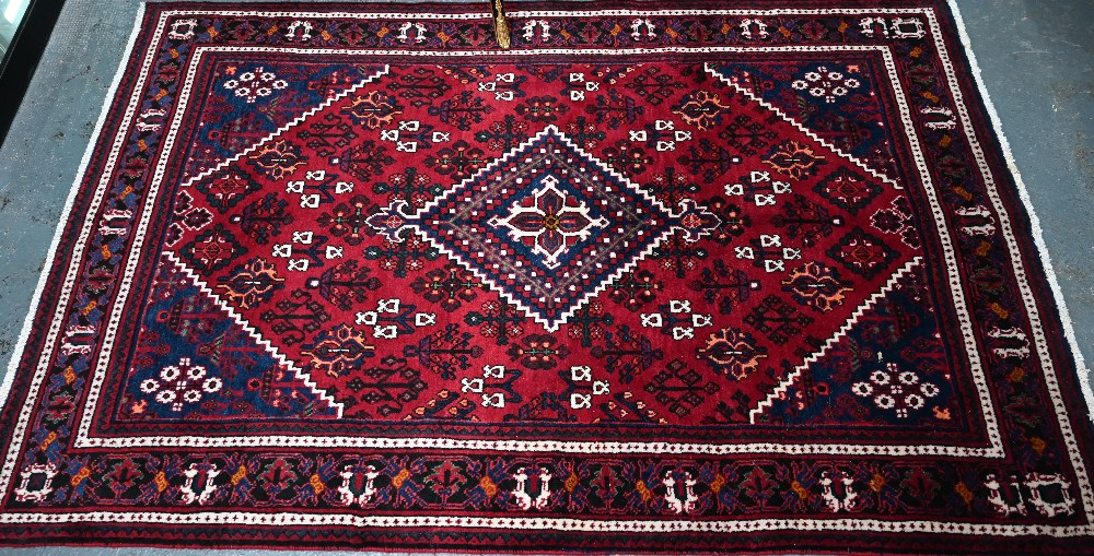 A North West Persian Josheghan rug, the deep red ground with geometric design, 215 cm x 135 cm