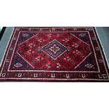 A North West Persian Josheghan rug, the deep red ground with geometric design, 215 cm x 135 cm