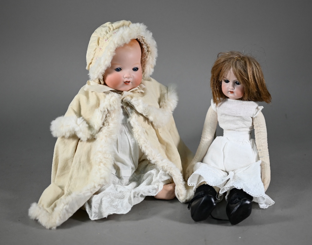 An Armand Marseille AM351/3 1/2 k bisque-headed baby doll with fixed blue eyes and open mouth with