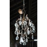 A gilt metal framed large crystal hung single light fitting, with ceiling fitting