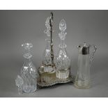 A Victorian electroplated decanter stand fitted with three cut glass decanters, to/w a glass
