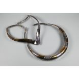 Two contemporary white metal necklace torques, stamped 925 and with etched signature (2)