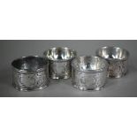 A set of four George III circular silver trencher salts with engraved rococo decoration, maker's