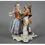 A Meissen porcelain group of two 18th century children, fingering each others flutes, after a