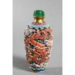 A Chinese moulded porcelain famille rose snuff bottle with green glass stopper, modelled with a