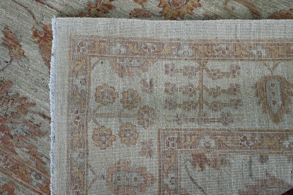 A contemporary Indian Agra carpet, the yelllow/ochre ground with muted floral design, 204 cm x 154 - Image 3 of 3