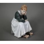 A Royal Copenhagen figure, Fanoe girl, seated and bored, 1324, 21 cm