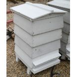 A traditional wooden bee hive, painted white