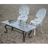 A glass top steel framed coffee table to/w a pair of Victorian style cast alloy garden chairs (3)