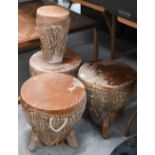 A trio of traditional Ugandan/African drums, 33 cm diam to/w another 18 cm diam drum (4)