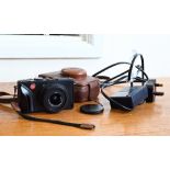 A Leica D-Lux 4 digital pocket camera with leather case and battery-charger with spare battery