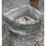 An antique cut stone demi-lune sink/trough
