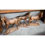 A trio of carved hardwood stallion sculptures (3)