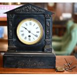 An early 20th century slate architectural mantel clock with drum movement c/w pendulum and key