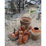 A collection of small terracotta pots to/w a part glazed two handled jug, a large terracotta pot and