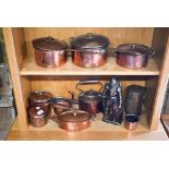 A collection of antique copper and brass saucepans to/w cast iron medieval knight companion set -