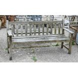 A weathered teak garden bench