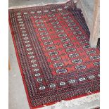 A Pakistani teke Bokhara rug, the repeating gul design on red ground, 184 x 125 cm