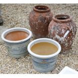 A pair of weathered Grecian style terracotta urns to/w a pair of glazed planters (4)