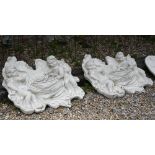 Two weathered cast composite putti wall pockets, approximately 68 cm h x 72 cm w (2)