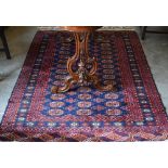 A Pakistani teke Bokhara rug, the repeating gul design on blue ground within repeating borders,