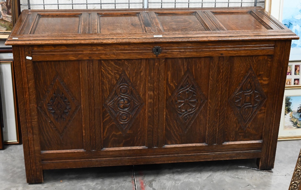 A traditional oak coffer with carved lozenge decoration, on stile feet, 133 x 55 x 76 cm high