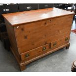 An antique waxed pine mule chest with hinged top and two drawers, raised on bracket feet, 110 x 56 x