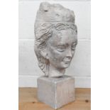 A cast stone female head, 45 cm high