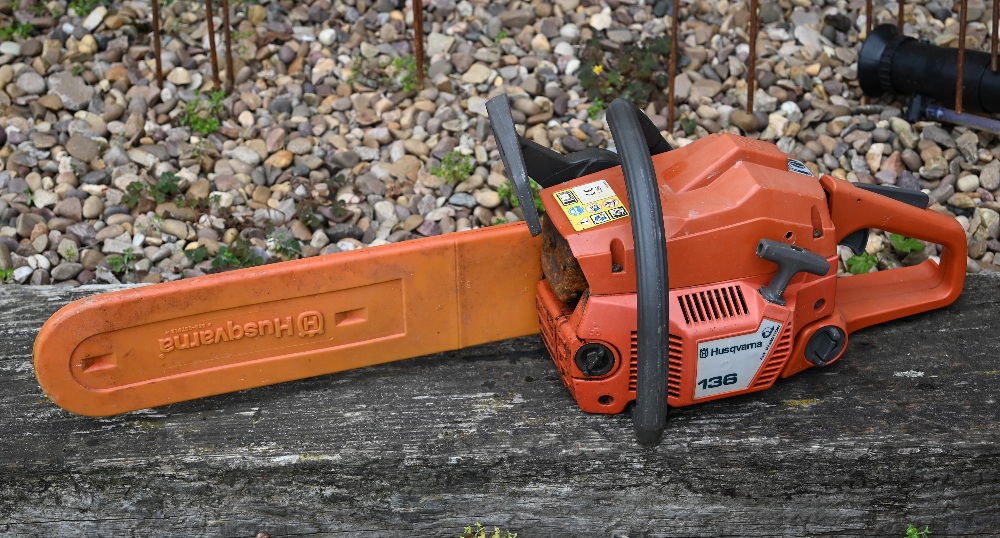 A used Husqvarna 136 chainsaw, as seen