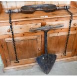 An antique wrought iron turf-lifter stamped 'Henry Carter', with wooden handle, to/w a carved wood