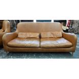Habitat - tan leather sofa and matching armchair designed by Aaron Probyn, raised on short turned