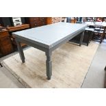 A rectangular dining table with panelled top on turned legs with two-tone grey paint finish, 200