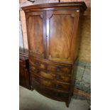 A Victorian mahogany bowfront two part linen press on chest of two short over three long graduated