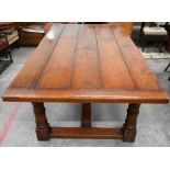 A good quality oak refectory style dining table with cleated five-plank top raised on turned legs