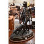 A large Continental bronze group of a huntsman and dog, unsigned, 62 cm high on oval base