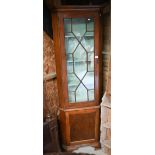 An antique mahogany part glazed floor standing corner cabinet