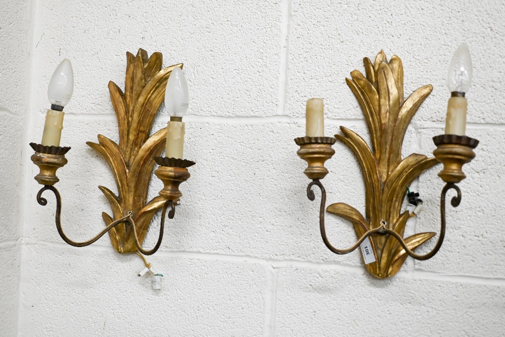 A pair of giltwood twin branch foliate wall sconces