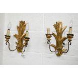 A pair of giltwood twin branch foliate wall sconces