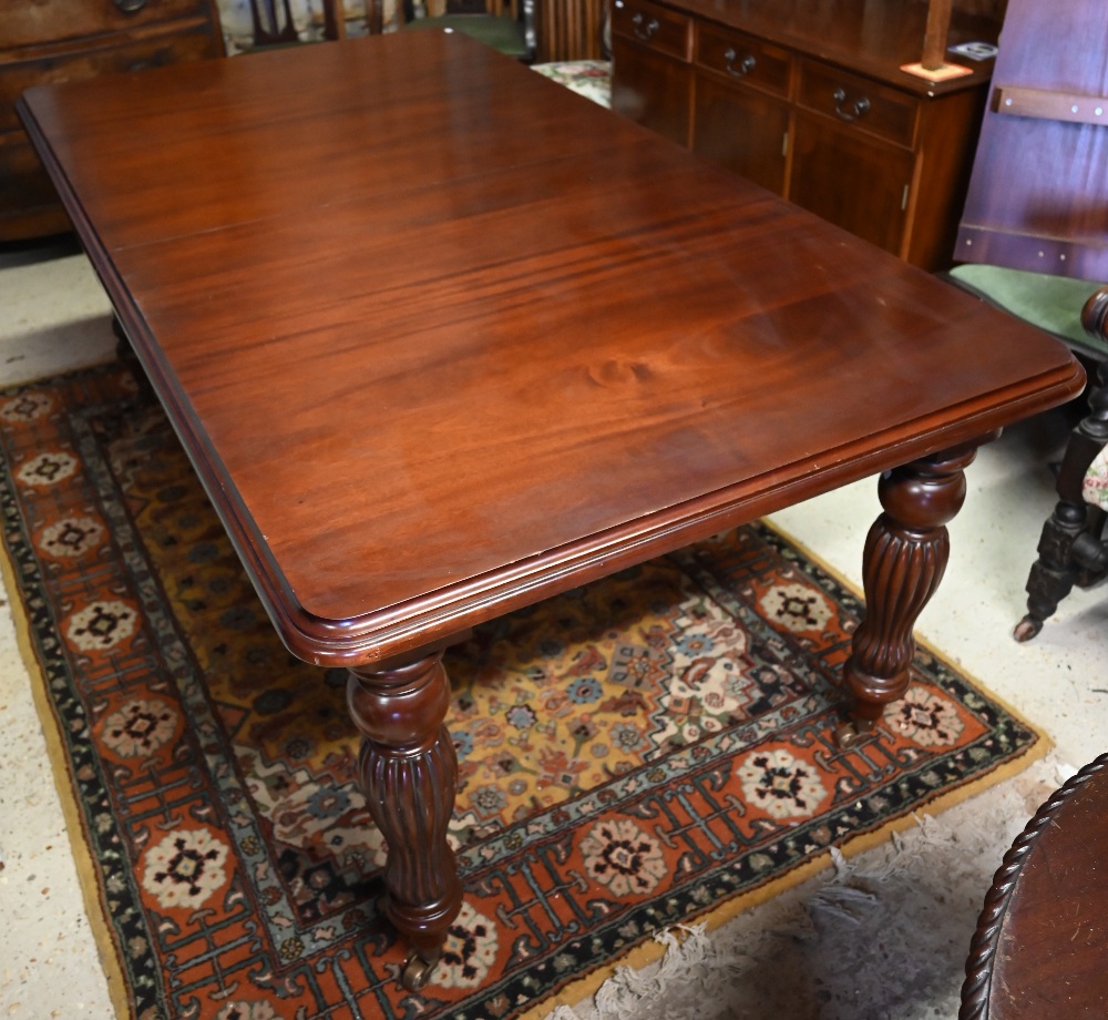 A Regency style mahogany extending dining table with single wide leaf raised on bobbin reeded turned