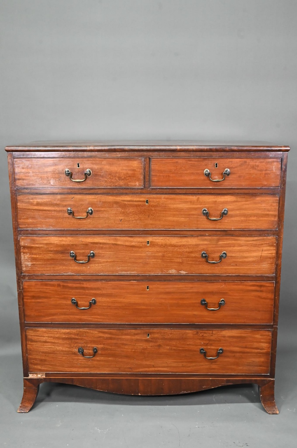 A George III mahogany chest of two short over four long graduated cock-beaded drawers, with brass