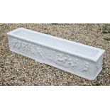 An antique style marble trough planter with relief cut frieze depicting a procession of frolicking