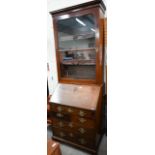 A Georgian mahogany fall front bureau with five drawers and associated glazed bookcase top