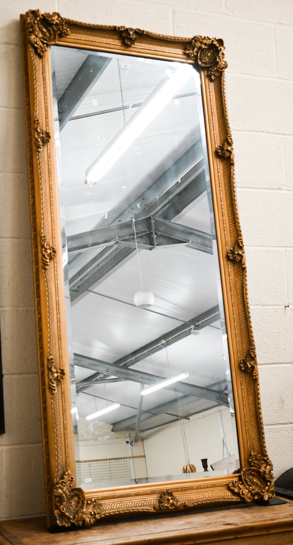 A large Baroque style gilt framed wall mirror with bevelled plate