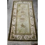 A small Chinese Peking style rug Shou symbols and auspicious motifs on green ground, 140 x 70 cm